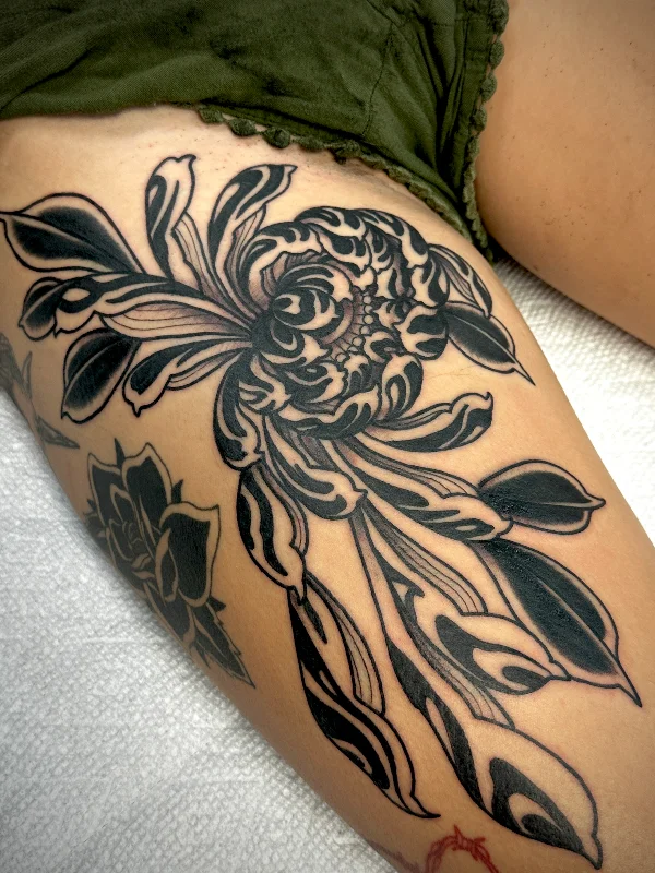 Blackwork flower tattoo with flowing petals by Castro