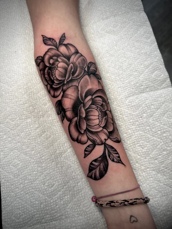Black and grey floral forearm tattoo by Castro
